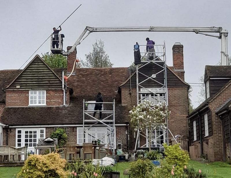The Moss Cleaners using cherry picker and scaffolding to clean roof safely and professionally in Studley, Warwickshire